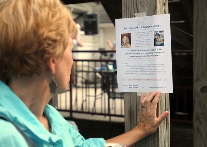 Joanne Goetz, of Oreland, reads a flyer posted at Johnny Apples in Holland on Sunday afternoon during a fundraiser to benefit 2012 Council Rock High School South graduate Lauren Shevchek, who was paralyzed and is now a quadriplegic as the result of a June 10 diving accident. The fundraiser will benefit the family for modifications they need for their home to accomodate Lauren. Goetz is a family friend.