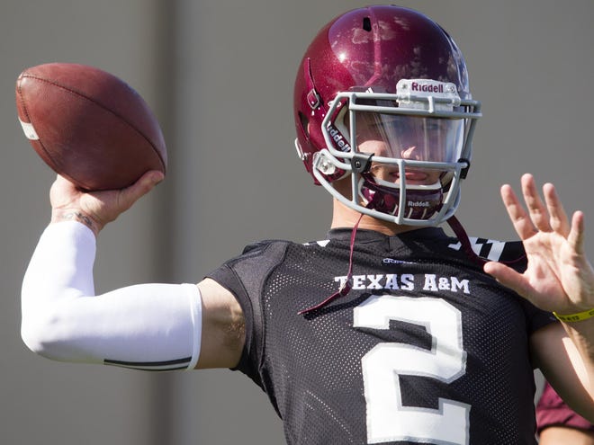 In this Aug. 5, 2013 file photo, Texas A&M quarterback and Heisman Trophy winner Johnny Manziel throws during football practice in College Station, Texas.