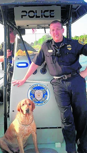 Lieutenant Eric Hill, with the Labrador retriever he helped to rescue from 
the Intracoastal Waterway on Aug. 7.
PHOTOS PROVIDED BY VENICE POLICE DEPARTMENT