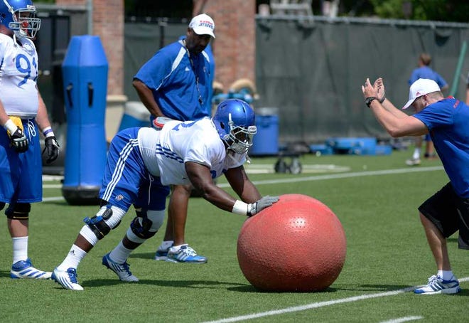 Marquel Combs pushes on a large ball during a defensive drill Sunday.