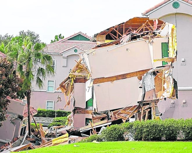 Damage to buildings caused by a sinkhole is seen Monday at the Summer Bay 
Resort in Clermont. Lake County Fire Rescue Battalion Chief Tony Cuellar 
said about 30 percent of the three-story structure collapsed during the 
night, and another section was sinking.AP PHOTO