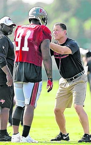 Tampa Bay Bucs head coach Greg Schiano, right, works with defensive end 
Da'Quan Bowers on blocking drills during training camp Aug. 6, in Tampa. 
ASSOCIATED PRESS