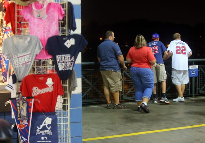 Baseball fans look over a railing at Turner Field near the scene where a man fell 60-plus feet from the upper deck Monday Aug. 12, 2013. Atlanta police spokesman John Chafee confirmed the death of the man, whose name has not been released. The man fell during Monday night's game between the Atlanta Braves and Philadelphia Phillies. (AP Photo/Atlanta Journal Constitution, Curtis Compton) MARIETTA DAILY OUT, GWINNETT DAILY POST OUT) LOCAL TV OUT (WXIA, WGCL, FOX 5).