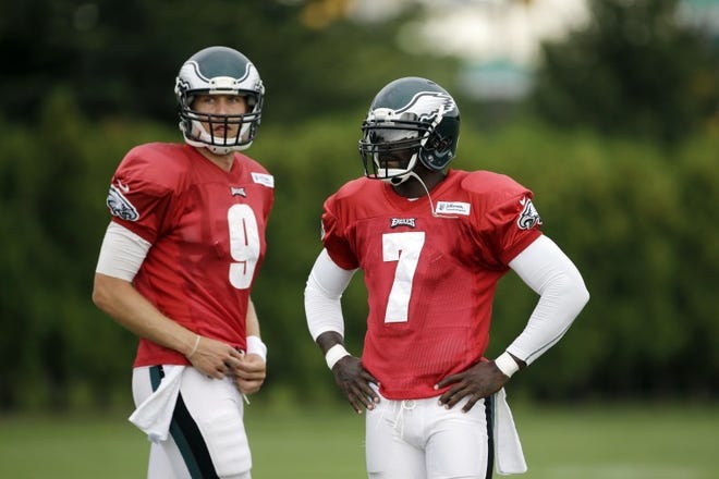 Eagles quarterbacks Michael Vick (7) and Nick Foles (9) wait to run a drill during a joint workout with the Patriots. Vick will start Friday night's preseason opener against New England.