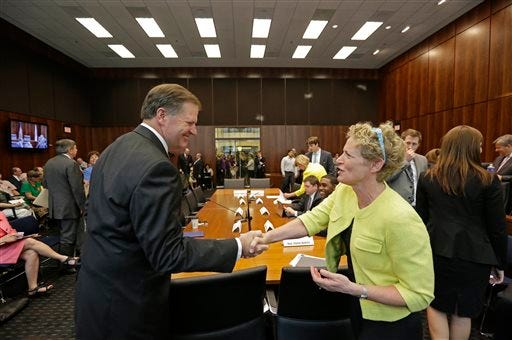 Illinois State Sen. William E. Brady, left, and State Rep. Elaine Nekritz, shake hands before Members of a bipartisan committee of Illinois lawmakers hold its first public pension hearing Thursday, June 27, 2013, in Chicago. Members of the panel tasked with coming up with a plan to address Illinois' pension crisis don't all agree with Gov. Pat Quinn's July 9 deadline to report back with a solution. The 10-member panel was formed after a special session this month. Both chambers remain divided and the group has been charged with finding compromise. Illinois has the worst state pension shortfall nationwide, largely due to lawmakers skipping or shorting payments to public-employee retirement funds. (AP Photo/M. Spencer Green)