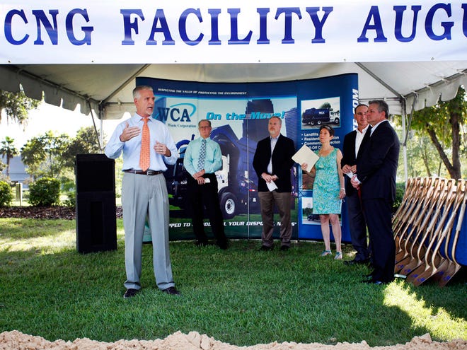 Representative Keith Perry, accompanied Wednesday by, left to right, Starke Mayor Travis Woods, Gainesville Mayor Ed Braddy, Gainesville City Commissioner Susan Bottcher, WCA Waste Corp. Regional Marketing Director Brad Avery, and regional vice president of WCA, Bob Shires, celebrates the groundbreaking of the first publicly accessible compressed natural gas fueling station that will be used by WCA's fleet of garbage trucks and open to the public at the Chevron near Williston Road and Interstate 75.