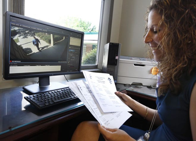 Principal Jen Homard of Littlewood Elementary School can watch a live feed in her office from the security cameras mounted at the front entrance at the school.
