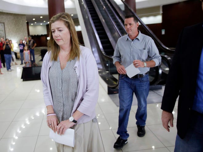 Matt Capobianco follows his wife Melanie into a news conference Wednesday in Tulsa, Okla., to speak about the continuing battle for Baby Veronica. The Capobianco's said that they were willing to make a deal that would allow them to regain custody of Veronica.