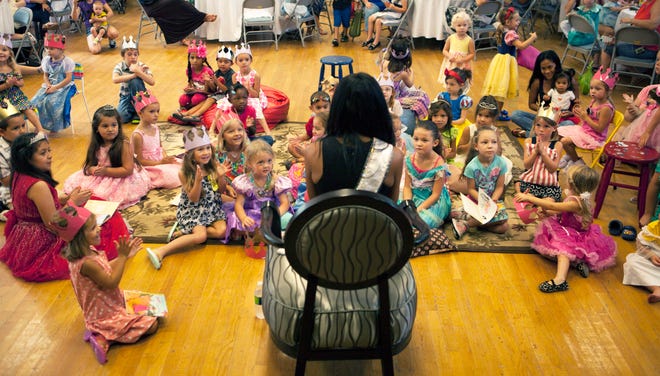 Miss N.C. USA Ashley Love-Mills reads to military children during the Jacksonville USO’s A Very Special Story Time Aug. 13.