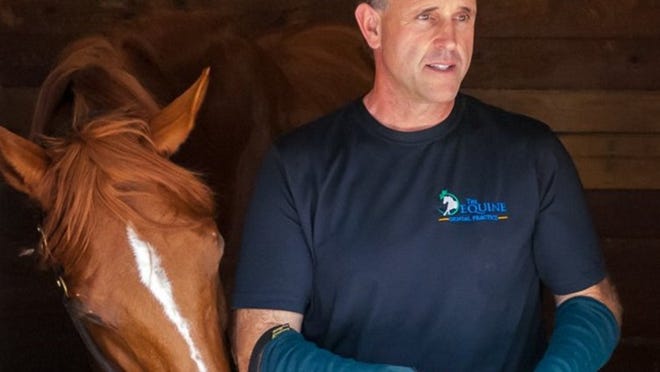 Dr. Geoff Tucker has practiced equine dentistry for 30 years. He uses only his hands to keep the horses’ mouths open. (Photo provided by Geoff Tucker)