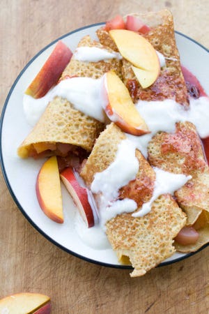 Corn crepes are stuffed with summer fruits. One of the earliest French culinary imports to make a dent in America was the crepe. (AP Photo/Matthew Mead)