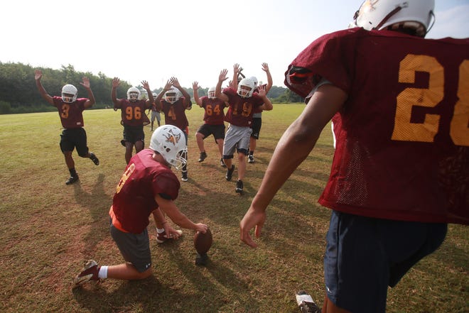 Thomas Jefferson Classical Academy players run a drill at a recent football practice.