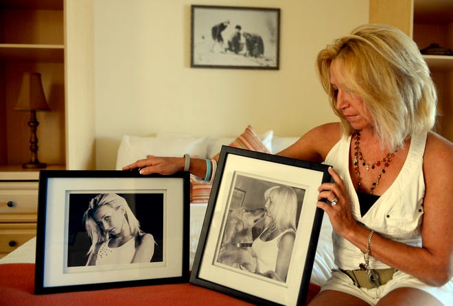 Kelly Osborn, mother of Sheena Morris, is shown with images of her daughter in this 2012 file photo shot in the hotel room where Morris' body was discovered.