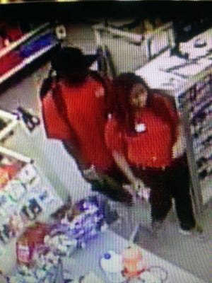 Photo provided by Savannah-Chatham police. The man pictured behind the woman in this photo is accused of robbing a Savannah Family Dollar store in July. Police are asking the public to help identify and locate him.