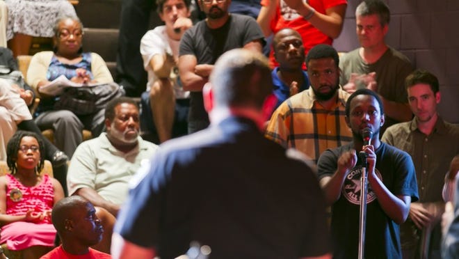Chas Moore tells Austin Police Chief Art Acevedo he should be fired or “burn in hell” at a meeting at the Carver Museum and Cultural Center in East Austin on Thursday night.