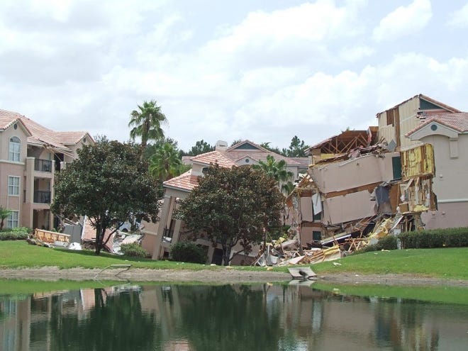 A portion of a building rests in a sinkhole Aug. 12 in Clermont. The sinkhole opened up overnight and damaged three buildings at the Summer Bay Resort.