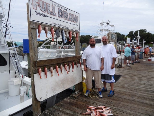 Ben Hawkins, left, and his brother Matt Hawkins pulled in a nice catch aboard the Full Draw. The two also spread the ashes of their father, Johnnie, while out doing what they all used to enjoy doing as a family — fishing on the Gulf of Mexico.