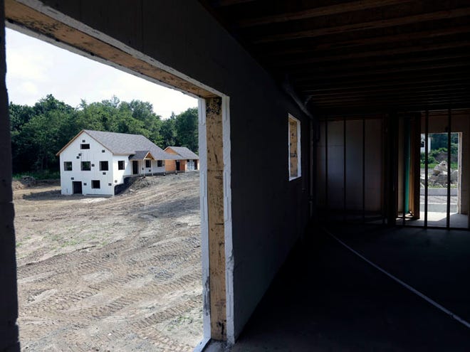 A zero net energy home under construction is seen from the interior of another at The Preserve at Mountain Vista on July 9 in New Paltz, N.Y. U.S. developers broke ground on homes at a faster pace in July. But the rise was all due to apartment construction, which is typically volatile.
