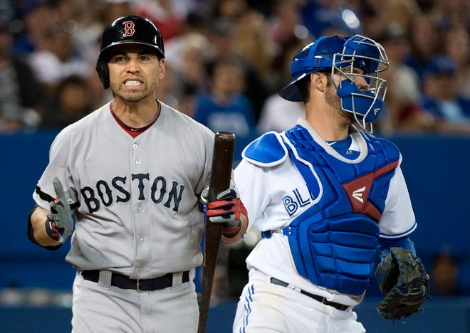 Following a strikeout, Boston Red Sox's Jacoby Ellsbury reacts next to Toronto Blue Jays catcher J.P. Arencibia during the eighth inning of a baseball game in Toronto on Thursday, Aug. 15, 2013.
