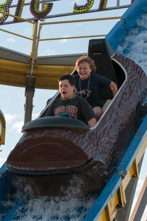 Tom Gioioso (front) and Matt Croke, both of Hanover, enjoy the “Big Splash” during the 2012 Marshfield Fair.