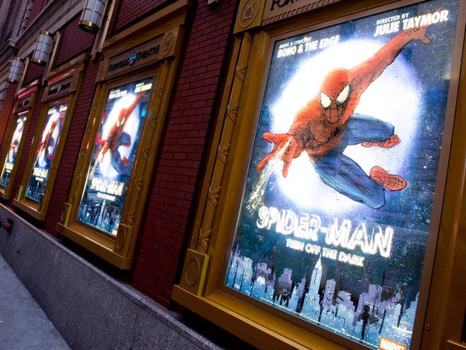 In this Dec. 22, 2010 file photo, posters for the Broadway musical "Spider-Man Turn: Off the Dark" hang outside the Foxwoods Theatre in New York. A spokesman for the show says an actor on the set of the Broadway musical was injured during a night performance, Thursday, Aug. 15, 2013. The performance was halted. The actor, who was taken to Bellevue Hospital with a serious leg injury, was identified as Daniel Curry. (AP Photo/Charles Sykes, File)
