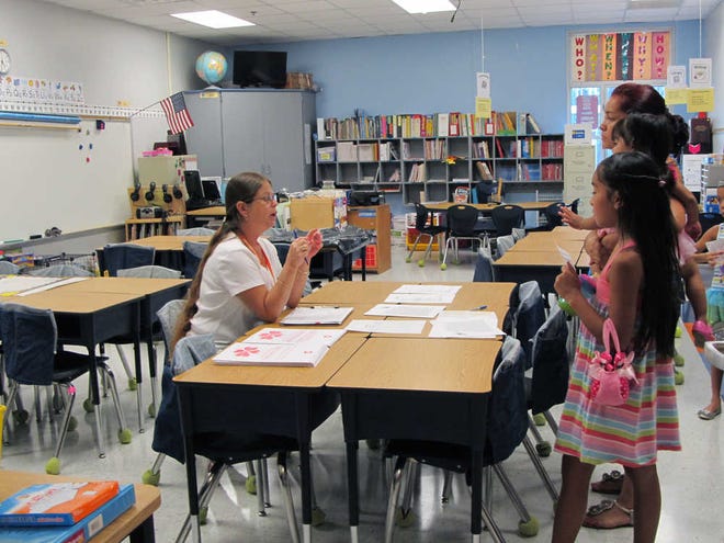 Jessicah Peters/Hardeeville TodayHardeeville Elementary School's second-grade teacher, Julie Williams, talks to her future student's family about the upcoming school year.