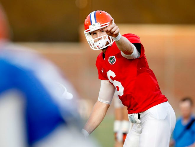 Florida quarterback Jeff Driskel signals to another player during an open practice session on Thursday.