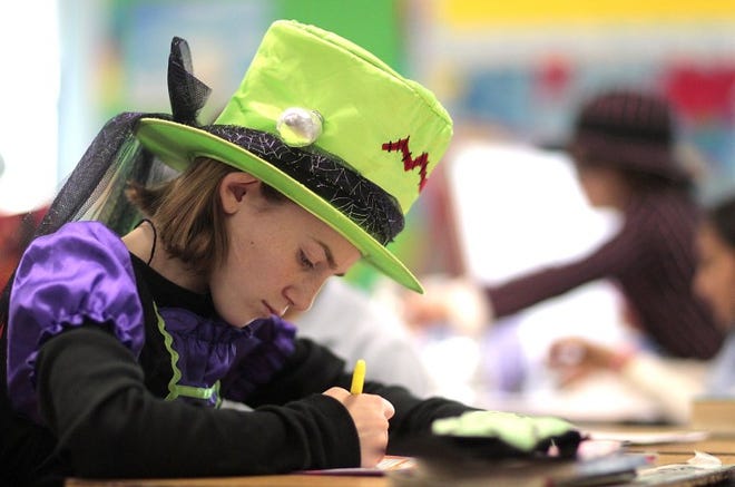 When it comes to learning vocabulary, students at the School Lane Charter School in Bensalem Township not only memorize words, but actually spend one day each year “embodying” their newly-learned lexicon. Here fifth-grader Payten Griffith, 10, studies while dressed as the Bride of Frankenstein to represent "horror" during Vocabulary Day on Monday morning. Students, teachers and staff made learning vocabulary a "treat" by donning outfits representing vocabulary words during the charter school’s annual event. The activity engages students in a creative and hands-on way to learn language, making academics more than just memorization.
