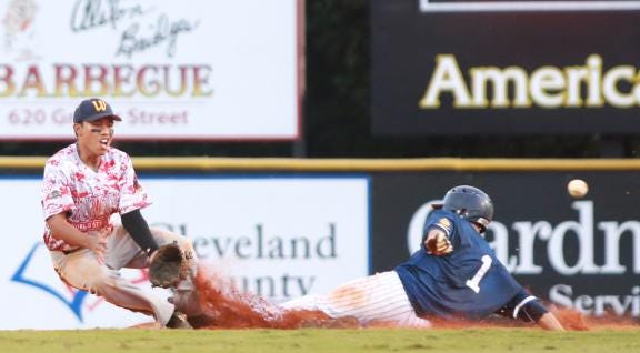 Reid Akau misses the ball as Gonzales' Robert Podorsky slides into second base.
