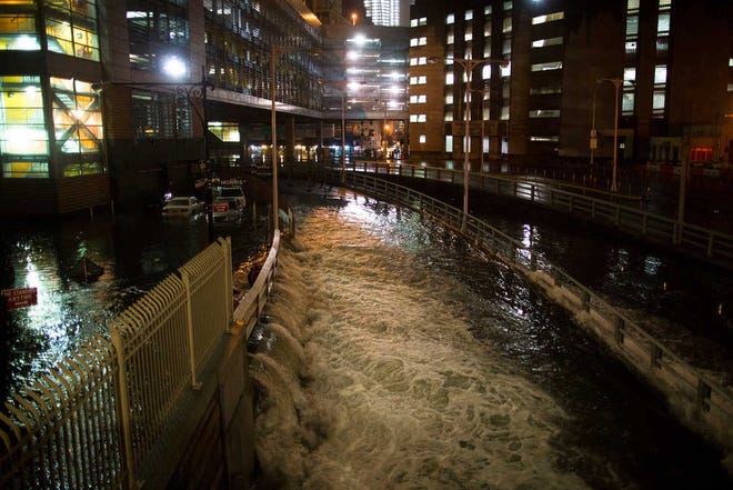 Seawater floods the entrance to New York City's Brooklyn Battery in the wake of Superstorm Sandy. A presidential task force charged with developing a strategy for rebuilding coastal areas damaged by Hurricane Sandy has made 69 recommendations.