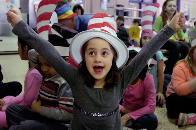Emma Castellano sings Happy Birthday to Dr. Seuss with other first grade students at McDonald-Davis Elementary School in Warminster on Friday. The school celebrates Read Across America and Dr. Seuss's 107th birthday.