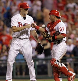 Philadelphia Phillies pitcher Jonathan Papelbon is congratulated by catcher Carlos Ruiz, right, after defeating the Colorado Rockies 5-4 in a baseball game, Monday, Aug. 19, 2013, in Philadelphia. (AP Photo/Laurence Kesterson)