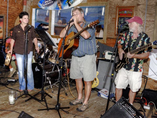Linda Snyder (left) joins Jeremy Truett (center) and John Keiffer at the Old American Fish Co. (shown below) on a recent Thursday night at ‘band practice.’ Photos by Gray Wells