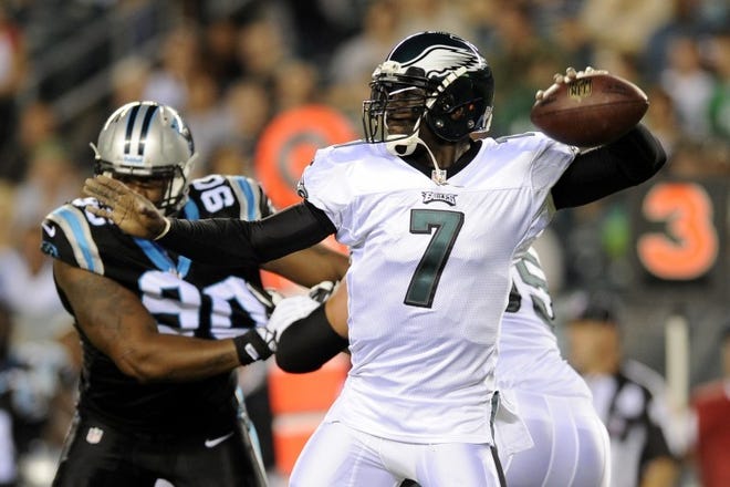 Eagles QB Michael Vick looks to pass during the first half of Thursday's preseason game against the Carolina Panthers.