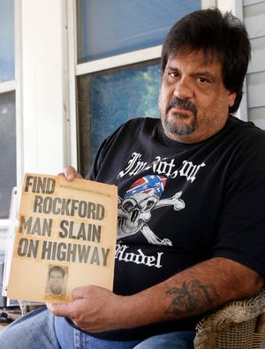 Jeff Martinez holds a newspaper clipping from 1962 about his father's killing on Tuesday, Aug. 20, 2013, in Rockford.