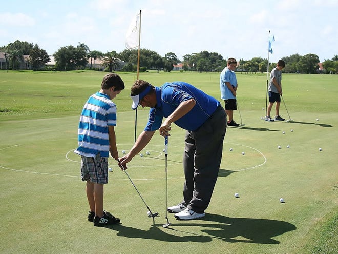 As part of the Big Brothers, Big Sisters of the Sun Coast Sports Buddies Program, the Plantation Golf and Country Club in Venice welcomed more than 20 Littles to the Club's teaching facility Aug. 10, for the opportunity to test their golf skills and learn more about the game. Shawn McCormick shows Little Cory Latour the basics of putting.