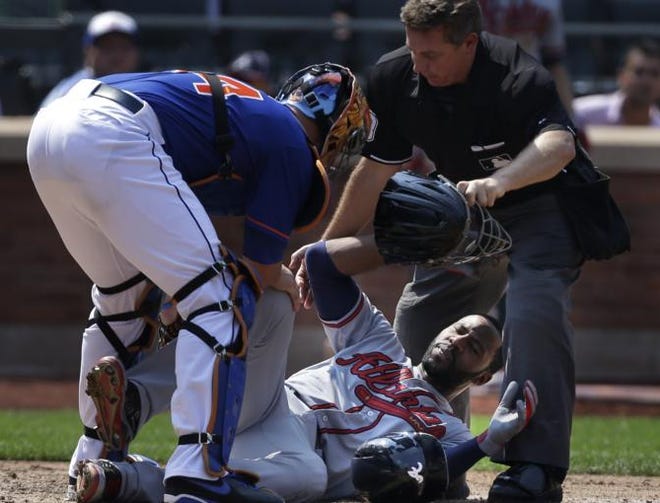 Atlanta Braves' Jason Heyward, center, is helped by New York Mets catcher John Buck, left, and umpire Greg Gibson after being hit by a pitch thrown by New York Mets' Jonathon Niese during the sixth inning of the baseball game at Citi Field Wednesday, Aug. 21, 2013 in New York.