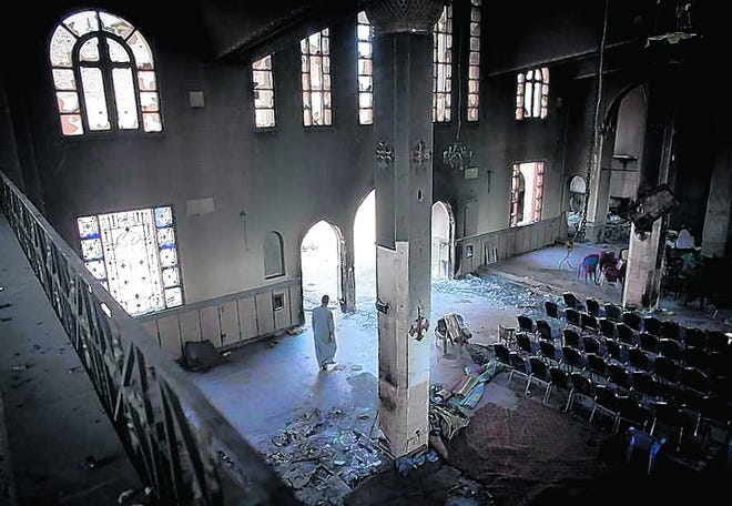A Coptic Christian walks through the destroyed New Church of the Virgin 
Mary, about 70 miles south of Cairo in the village of El Nazla on Monday. A 
wave of attacks on the Christian minority has washed over Egypt.TARA 
TODRAS-WHITEHILL / THE NEW YORK TIMES
