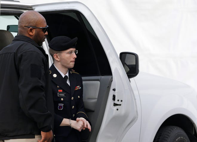 Army Pfc. Bradley Manning steps out of a security vehicle as he is escorted into a courthouse in Fort Meade, Md., Wednesday, Aug. 21, 2013, before a sentencing hearing in his court martial. The military judge overseeing Manning's trial said she will announce on Wednesday his sentence for giving reams of classified information to WikiLeaks. (AP Photo/Patrick Semansky)