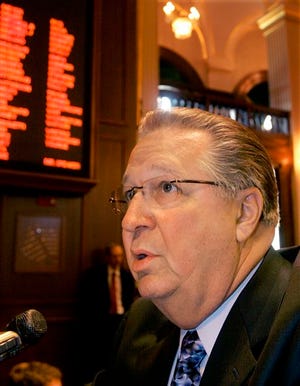 Illinois Rep. Raymond Poe, R-Springfield, talks with reporters while on the House floor during session at the Illinois State Capitol in Springfield, Ill., Tuesday, May 6, 2008. (AP Photo/Seth Perlman)