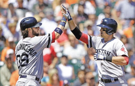 Boston’s Will Middlebrooks (right) is congratulated by teammate Jarrod Saltalamacchia after hitting a two-run home run during Wednesday’s 12-1 win over the Giants in San Francisco.