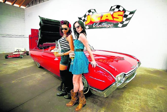 Two women lean against a classic car at last years annual Heatstroke Hotrod 
Hoedown at P-Man's Classic Cycle Paint in Bradenton.HERALD-TRIBUNE ARCHIVE / 
2012