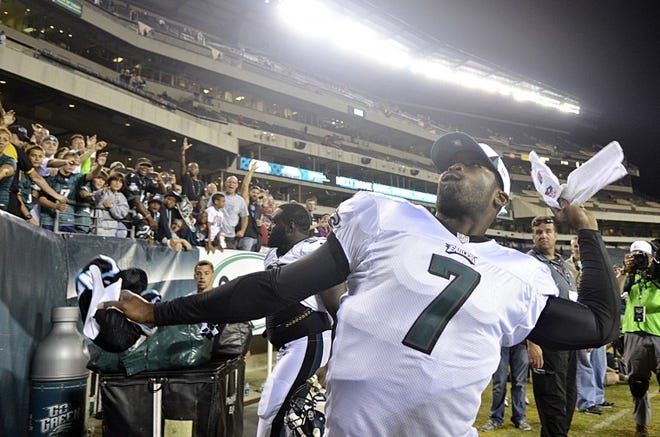 Eagles quarterback Michael Vick throws a towel to fans after a preseason game against the Carolina Panthers at Lincoln Financial Field in Philadelphia on Thursday, Aug. 15, 2013. The Eagles beat the Panthers 14-9.