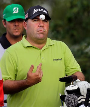 Kevin Stadler tosses a golf ball while waiting to hit a tee shot on the 16th hole during the first round of The Barclays, Thursday in Jersey City, N.J. Stadler is the leader after the first day.