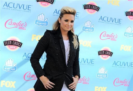 In this Aug. 11, 2013 file photo, Demi Lovato arrives at the Teen Choice Awards at the Gibson Amphitheater, in Los Angeles. Lovato will appear on multiple episodes of the upcoming fifth season of "Glee," her publicist confirms.