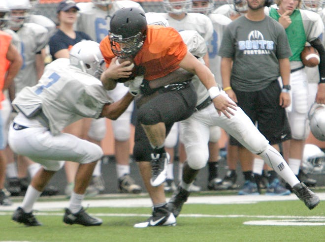 Massillon's JD Crabtree breaks a tackle by Willoughby South's Ben Robinson and Frankie Fox.
