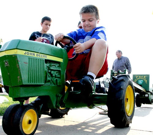Jamie Mitchell • Times Record Nathaniel Elmore, 8, tries to get another push on the pedal Thursday at the Arkansas Valley Antique Tractor Club’s pedal-pull during the annual Sebastian County Fair in Greenwood. The fair runs through Saturday. 
 Jamie Mitchell • Times Record Ivalynn Branum shows one of her cinnamon queen laying hens and her Grand Champion’s ribbon Thursday after the 4-H poultry show at the Sebastian County Fair in Greenwood. Ivalynn is the 9-year-old daughter of Russ and Marilyn Branum of Greenwood. 
 Jamie Mitchell • Times Record Kylie Brown uses her phone to capture an image of her winning art entry Thursday at the annual Sebastian County Fair art contest in Greenwood. Kylie is the 12-year-old daughter of Debbie Brown and attends Hackett Junior High. Entries to the various craft catagories are on display in the economics building at the fairgrounds through Saturday.