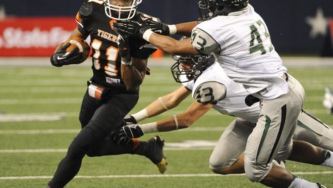 Cedar Park’s Blake Bouffard (13) and Thomas Hutchings (43) tackle Lancaster’s Nick Harvey during the 2012 Class 4A, Division II championship game. Bouffard and Hutchings both return to a defense that allowed 11.6 points per game last season.