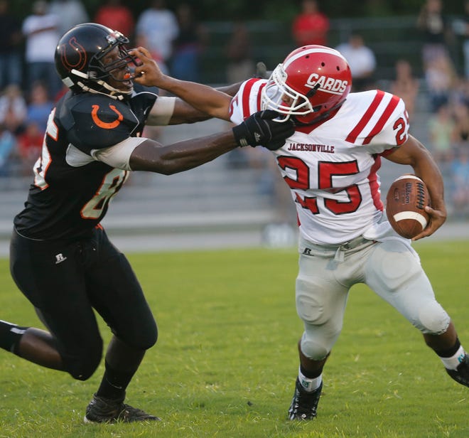 Jacksonville's Jermaine Linton, right, tries to fight off Southwest's Jimmie Smith on Friday night.
