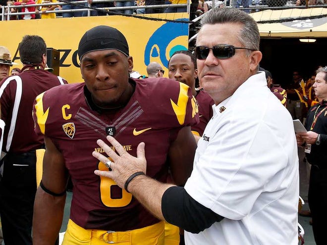 ADVANCE FOR WEEKEND EDITIONS, AUG. 24-25 - FILE - In this Nov. 17, 2012 file photo, Arizona State coach Todd Graham, right, stands next to Cameron Marshall prior to an NCAA college football game against Washington State in Tempe, Ariz. As a kid growing up in Dallas, Graham had two people who helped shape his coaching philosophy. One was former Dallas Cowboys coach Tom Landry, a person he never met. The other was his seventh-grade football coach. (AP Photo/Ross D. Franklin, File)